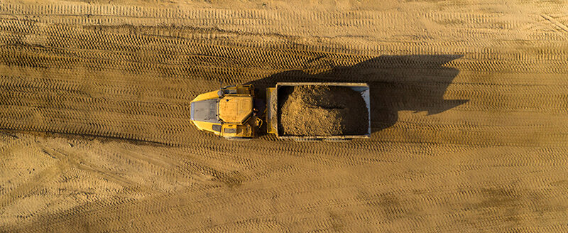 View from the top of truck with soil driving on a construction site