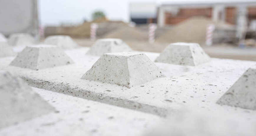 A selective focus of interlocking concrete blocks under the sunlight with a blurry background